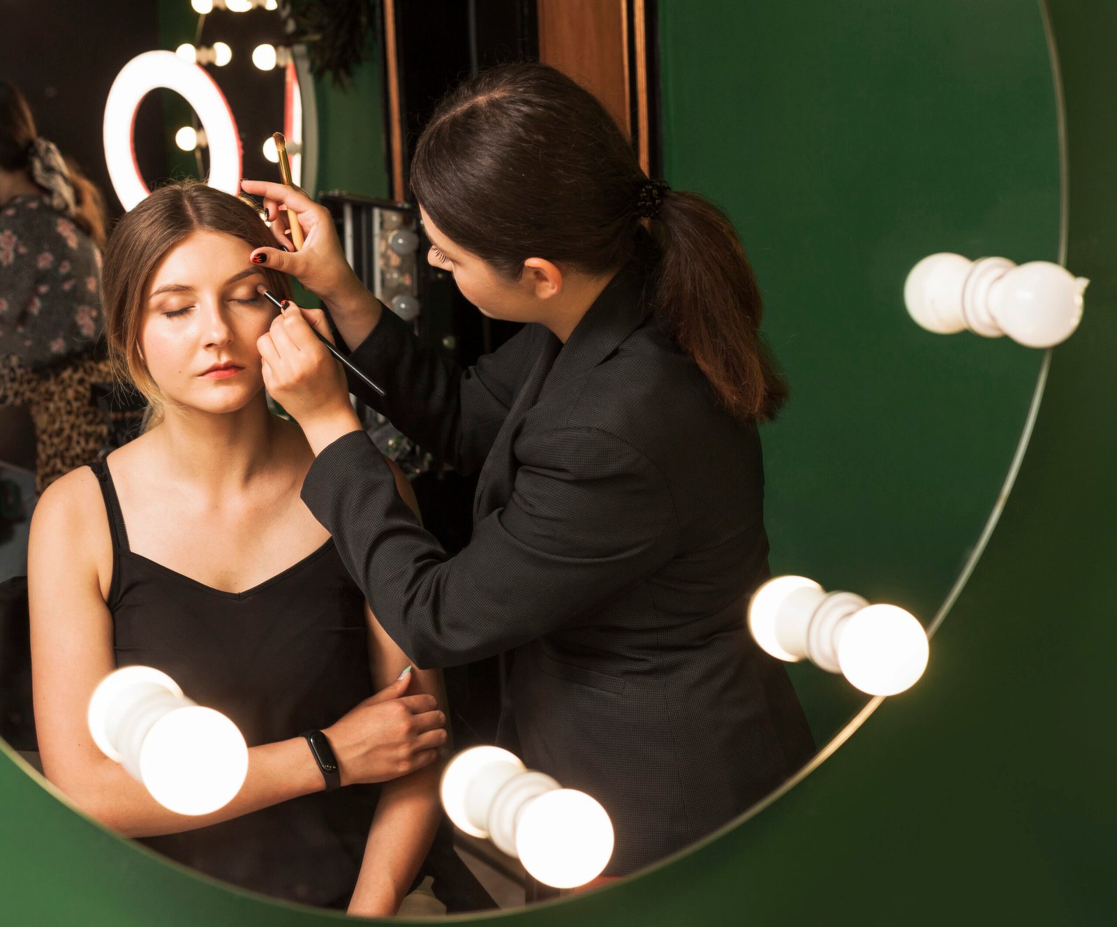 professional-woman-making-up-girl-s-eyes